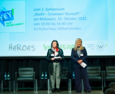 YeY Symposium Moderatorinnen: Gudrun Zollner, W³ Projektleiterin Landshut (l.), Tatjana Tichy, gfi Leitung Produktmanagement (r.) stehen auf der Bühne